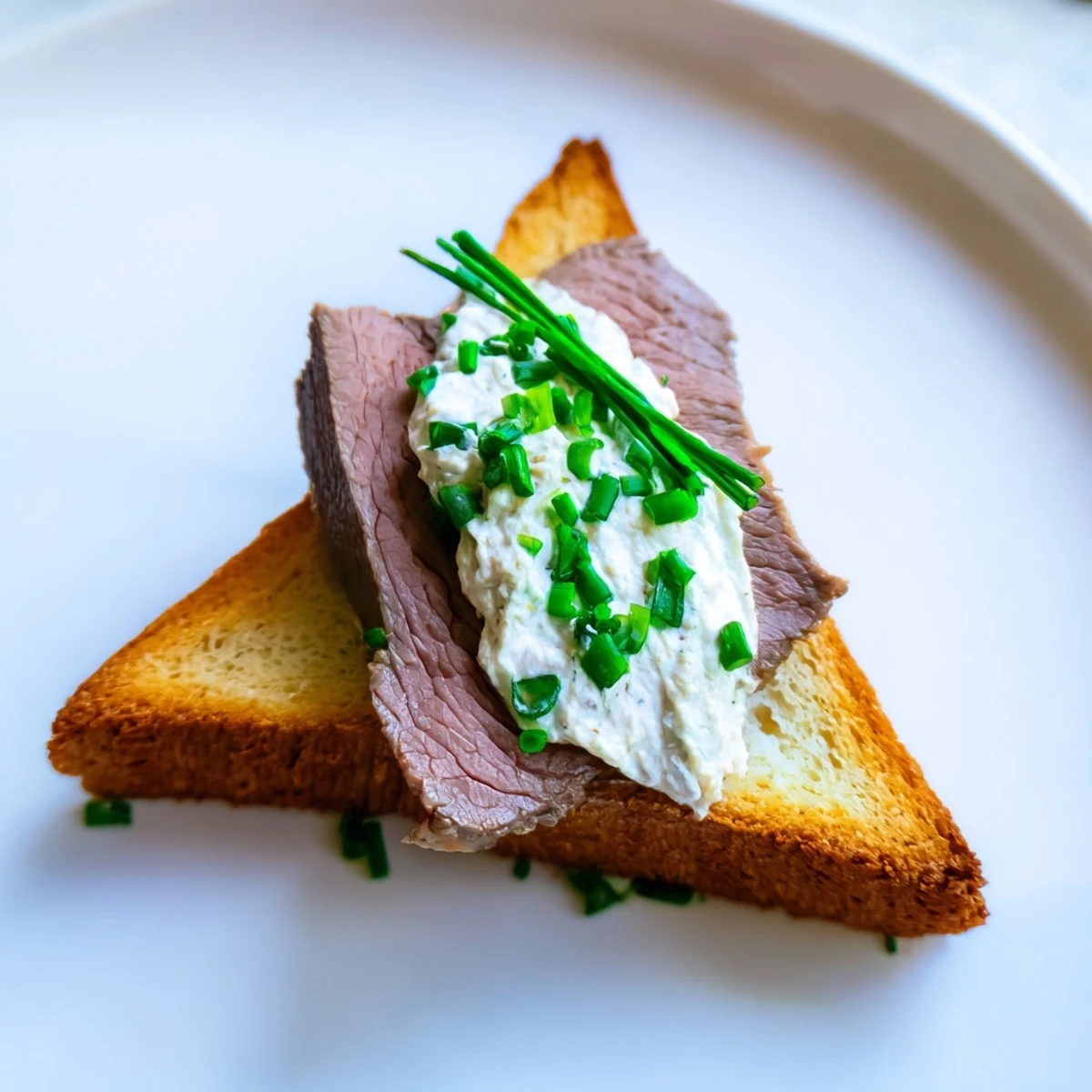 Golden-brown Beef Toast Points topped with tender seared beef and a dollop of zesty horseradish cream.