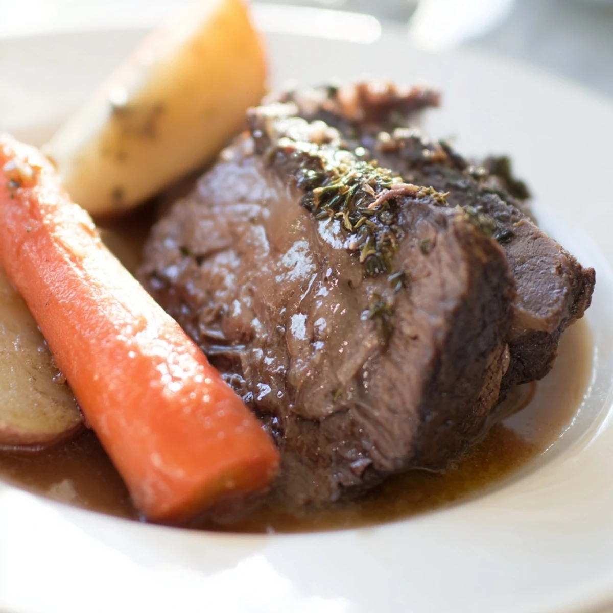 A hearty Beef Supper Roast resting with caramelized onions and herbs, ready for dinner.