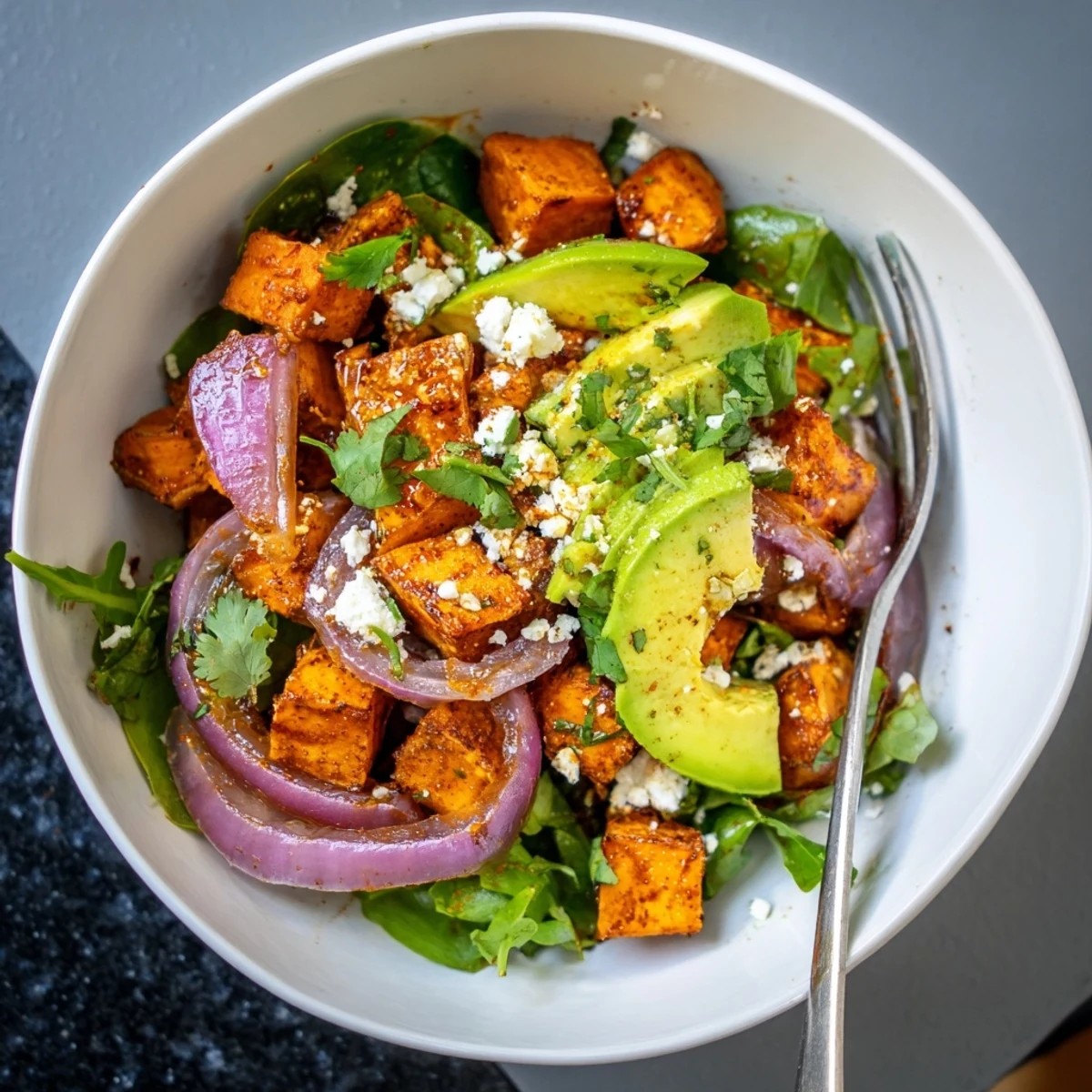 Golden roasted sweet potatoes and red onions tossed in a zesty lime dressing for a vibrant, nutritious salad.