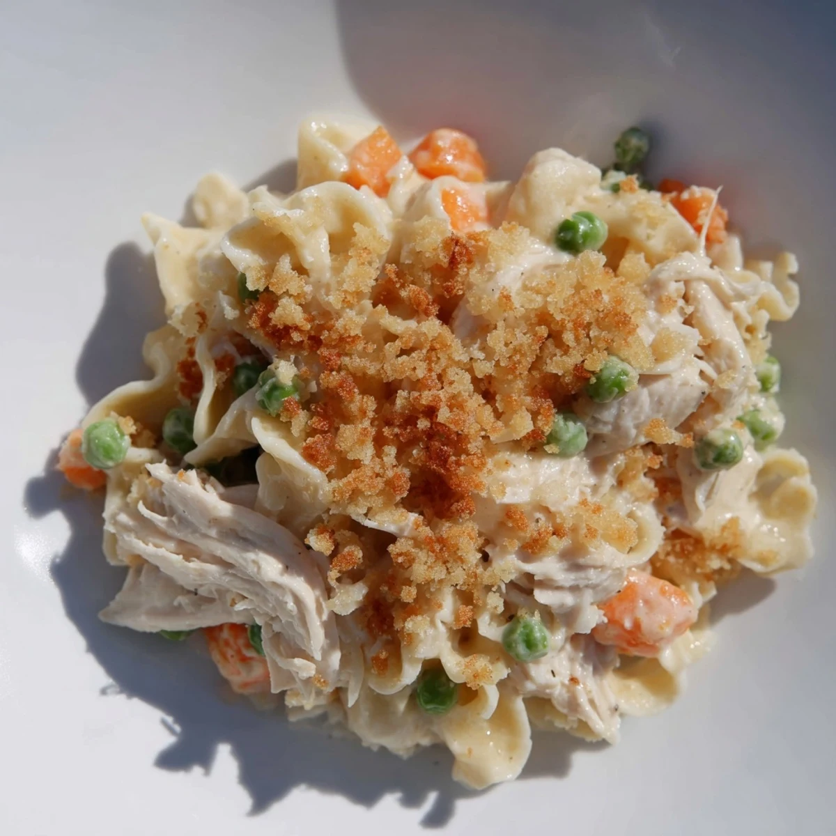 Family-style Chicken Noodle Casserole with Crumble in a white dish, ready to serve for dinner.