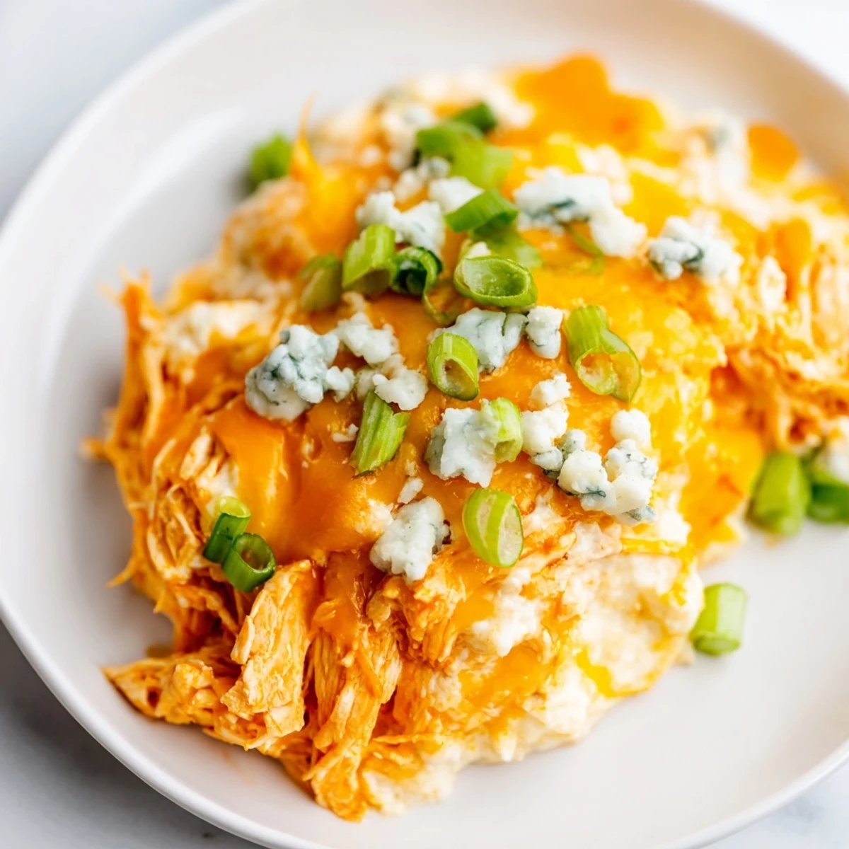 Creamy Keto Buffalo Chicken Dip baked golden and bubbly, served warm with crisp celery sticks for dipping.