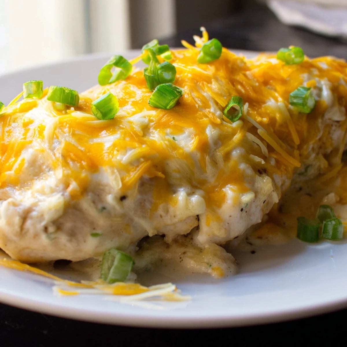 Tender baked Sour Cream and Onion Chicken breasts with a creamy sauce, served alongside steamed broccoli.