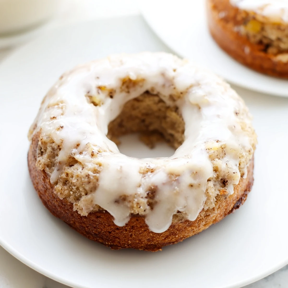 Golden Baked Banana Bread Donuts with a sweet vanilla glaze, arranged on a wire cooling rack for breakfast.