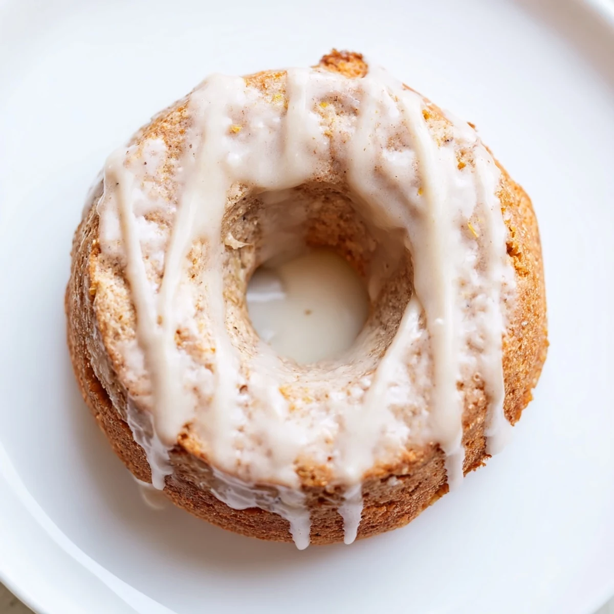 Freshly baked Baked Banana Bread Donuts dusted with powdered sugar, perfect for a cozy morning snack or dessert.
