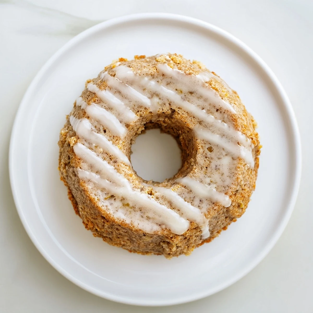 Moist, tender Baked Banana Bread Donuts showcasing ripe banana swirls and warm spices, ready to be served.