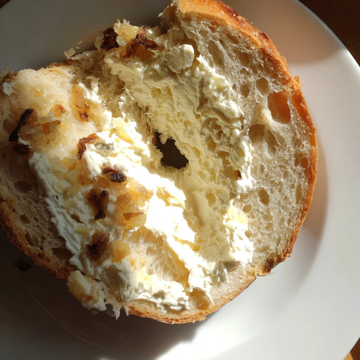 Freshly baked Sourdough Onion Bagels with golden, crispy crusts and sweet caramelized onions on top.