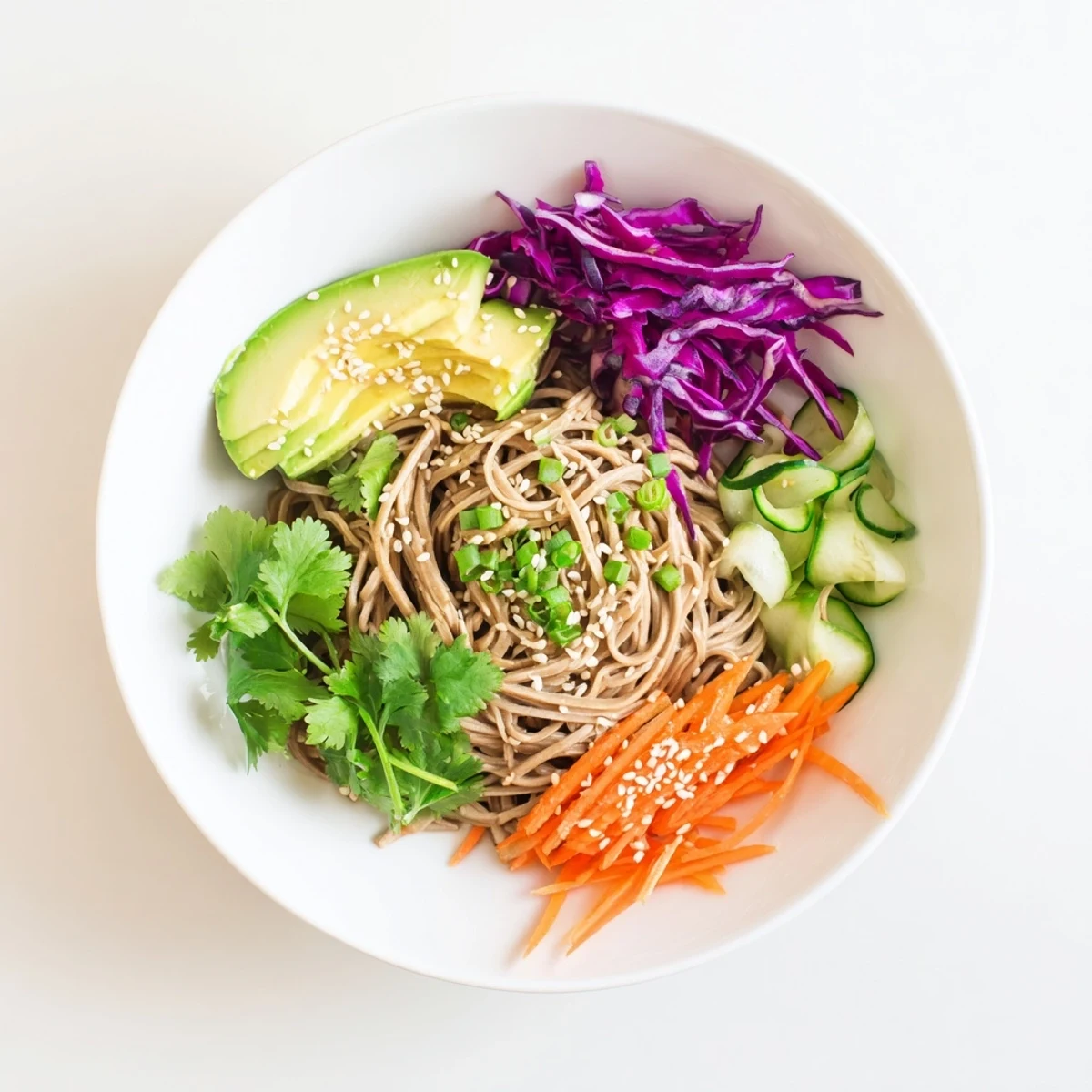 Creamy diced avocado and sesame-coated soba noodles mingle with crisp red cabbage and julienned carrot in this vibrant salad.