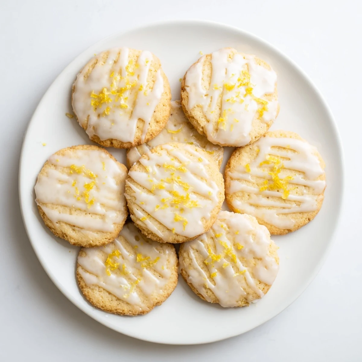 Freshly baked Limoncello cookies with a glossy lemon glaze, arranged on a rustic wooden board for a sunny spring gathering.