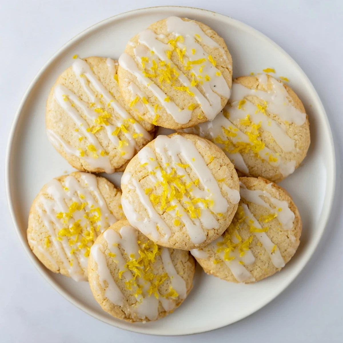 Homemade Limoncello cookies on a cooling rack, zesty lemon aroma, perfect dessert for a summer Italian-inspired party.