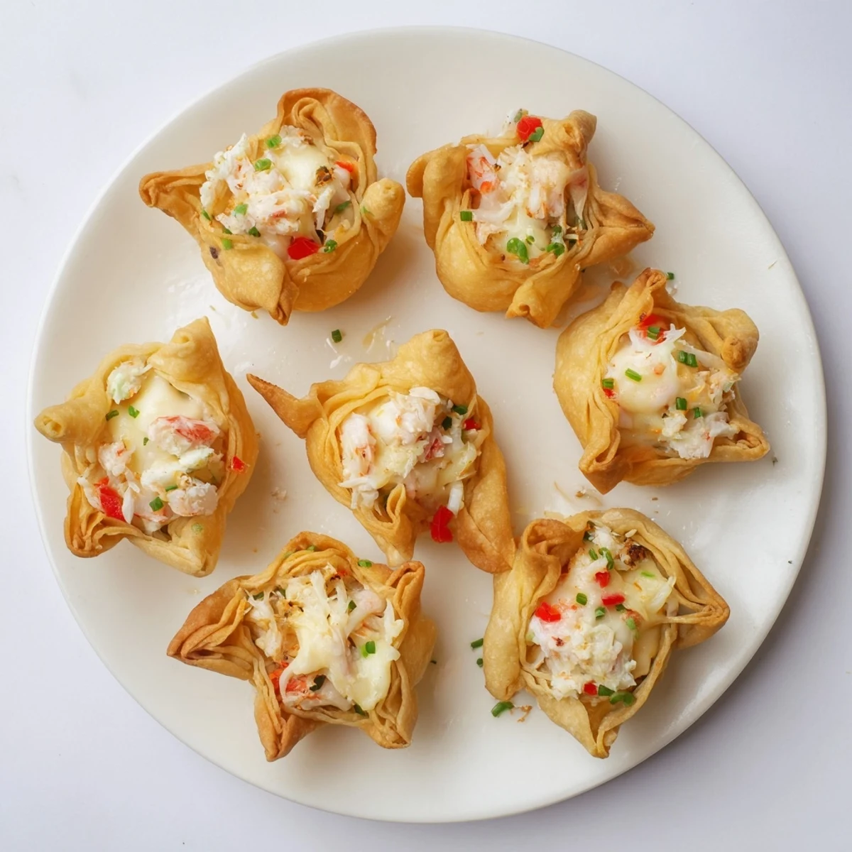 A close-up of Cheesy Seafood Tortilla Bombs on a platter, showing melty cheese and fresh herbs.