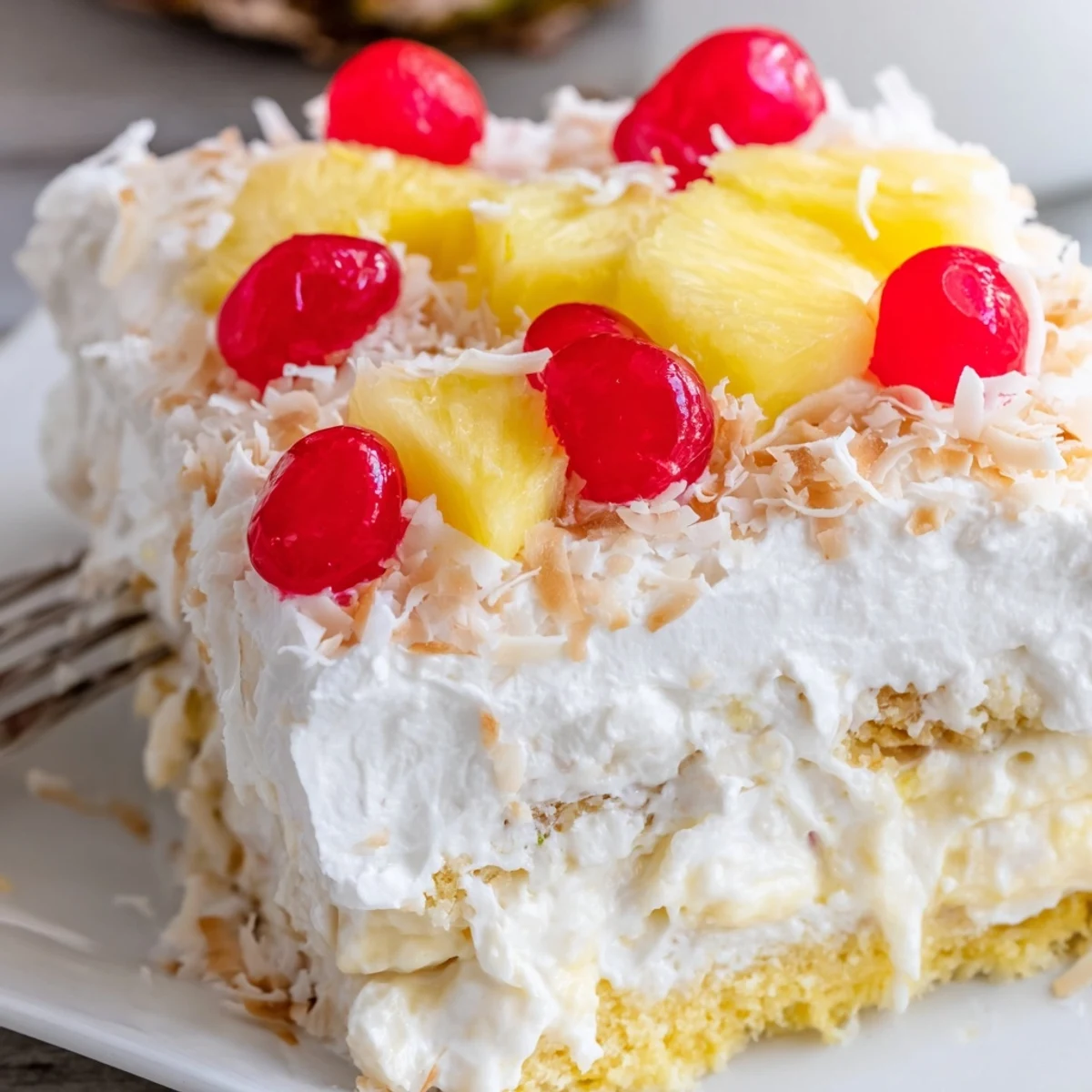 Moist tropical Hawaiian poke cake drizzled with sweetened condensed milk and garnished with pineapple