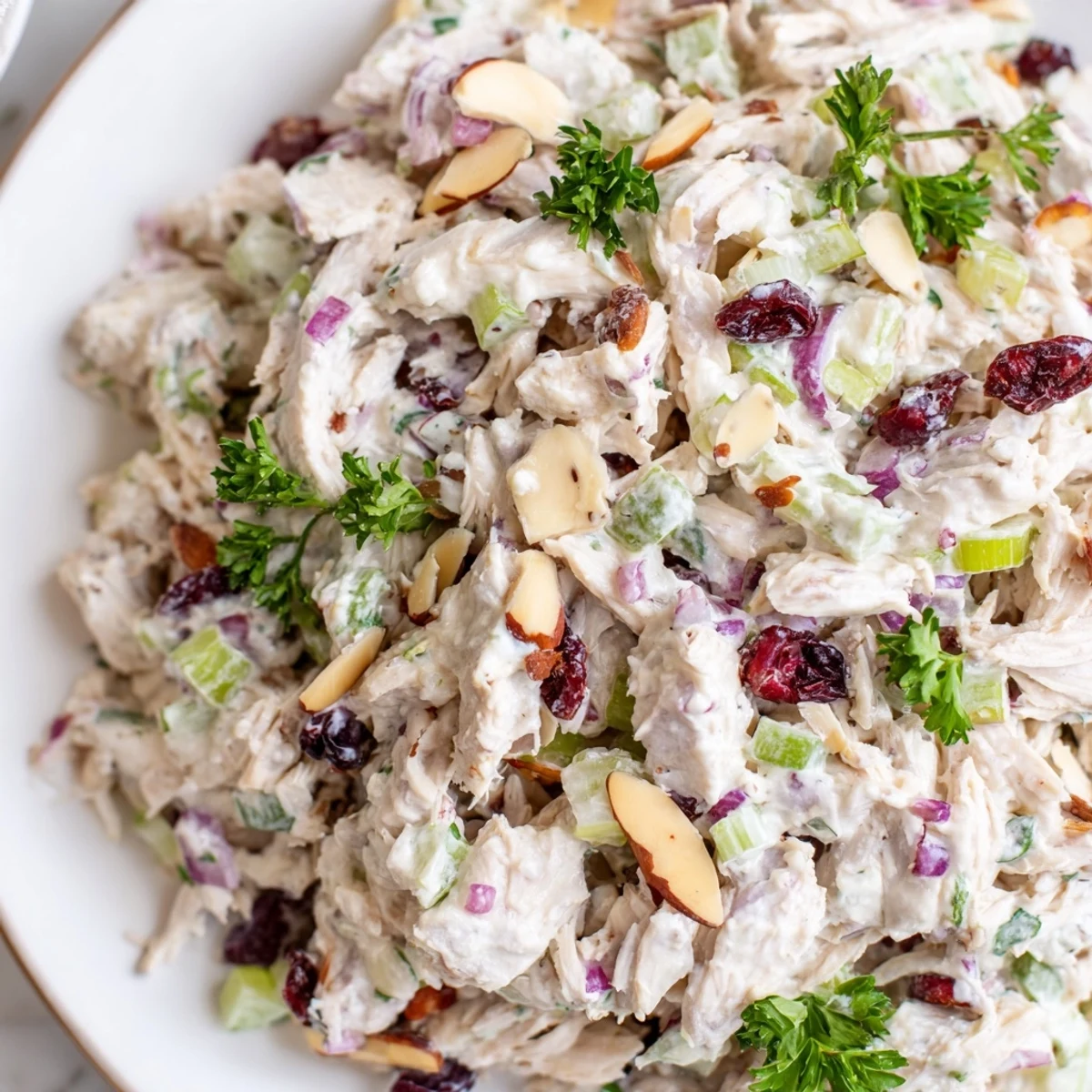 Light and protein-packed Greek yogurt rotisserie chicken salad served over fresh greens with diced vegetables