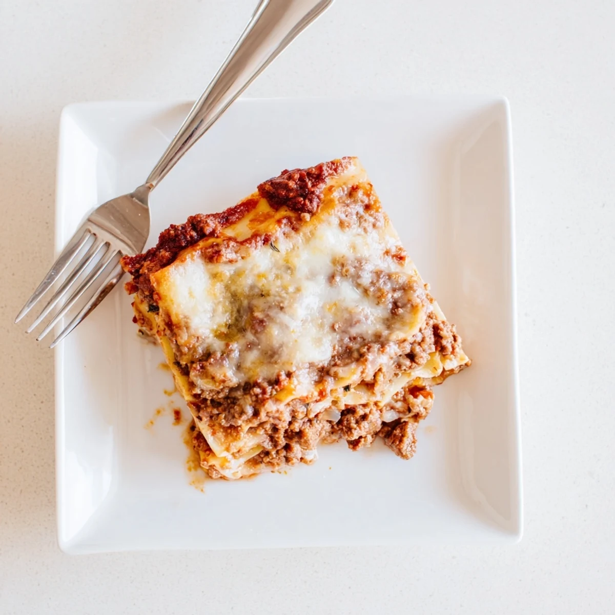 Golden classic lasagna with bubbling cheese layers and rich meat sauce in a rectangular baking dish