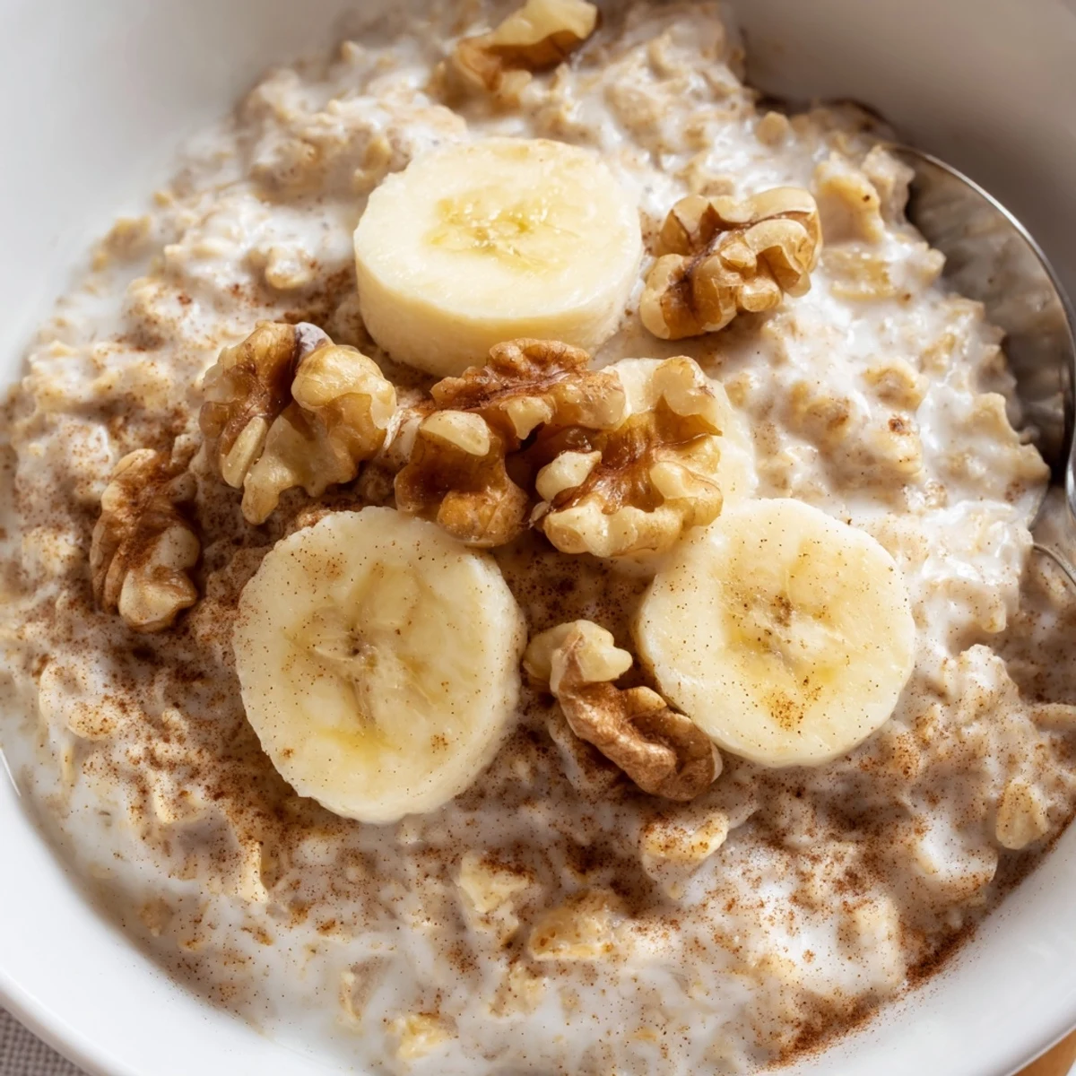 Mason jar displaying make-ahead brown sugar overnight oats with yogurt swirl and nut topping