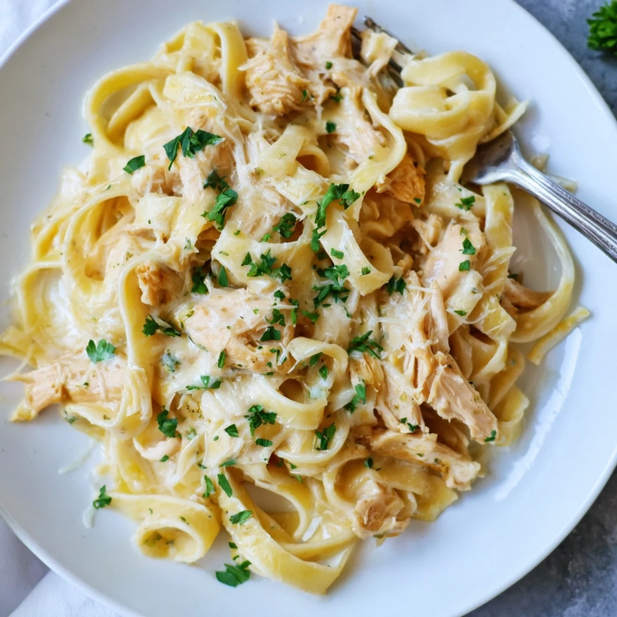 Creamy Crock Pot Chicken Alfredo with tender fettuccine pasta tossed in rich Parmesan sauce