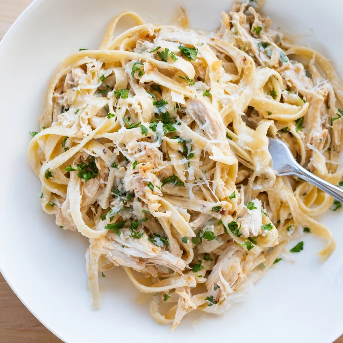 Comforting Italian-style Crock Pot Chicken Alfredo featuring shredded chicken and velvety white cream sauce