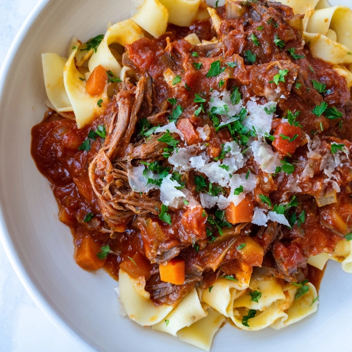 Hearty slow cooker beef ragu featuring fork-tender meat in a rustic red wine and tomato sauce