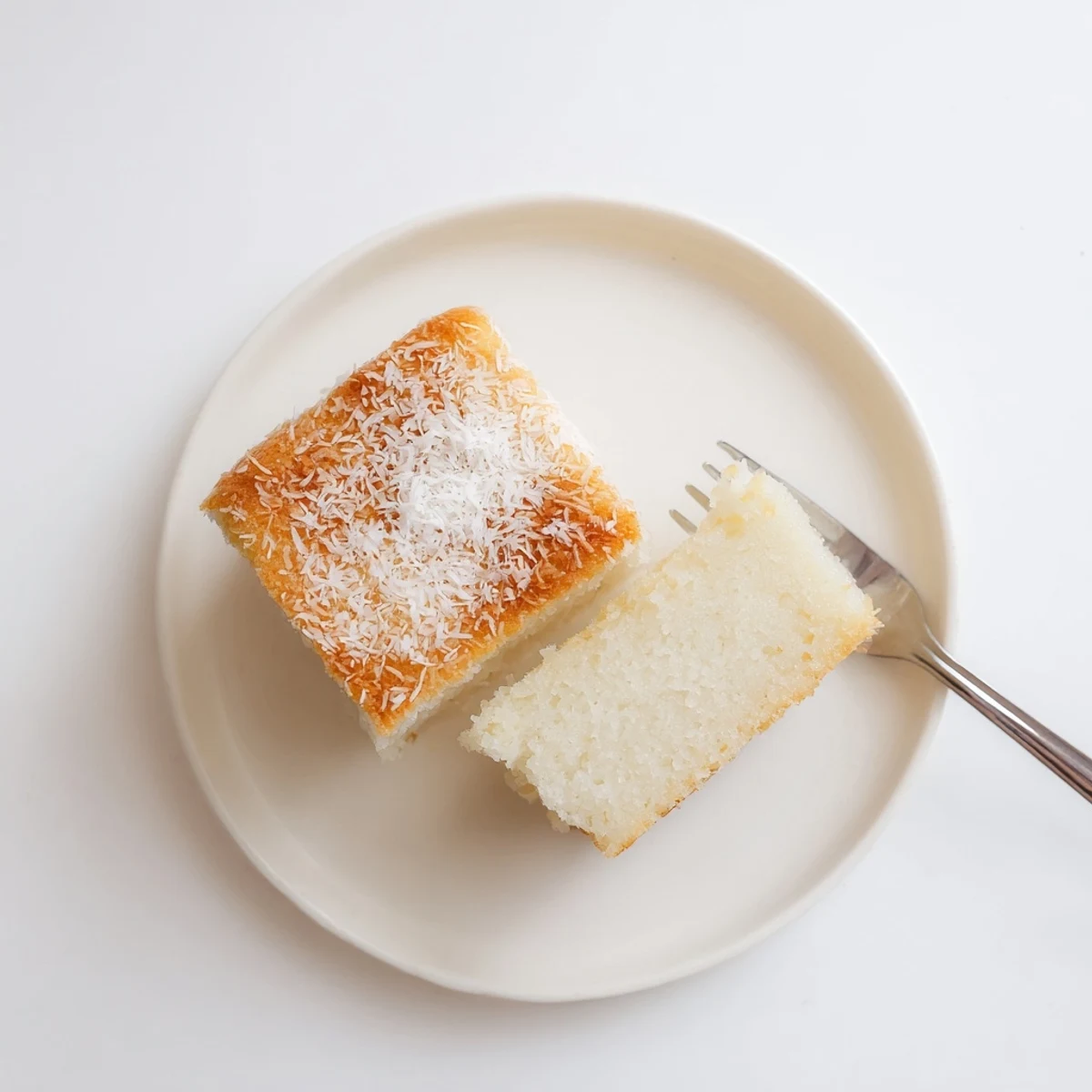Chewy gluten-free coconut mochi cake sliced into squares for dessert serving