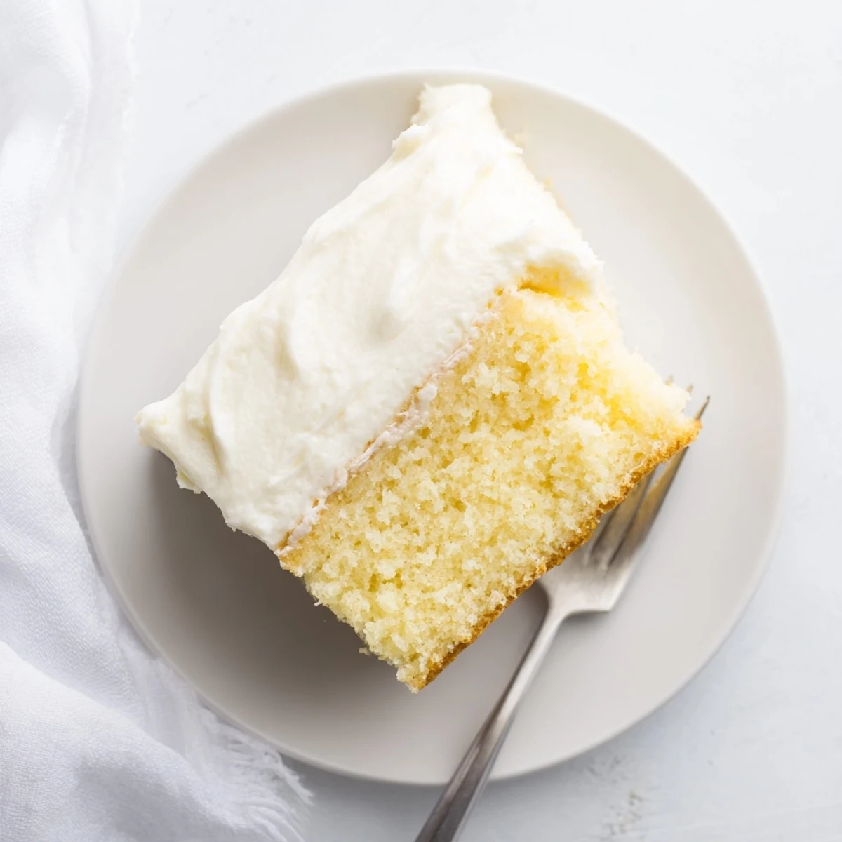 Light and airy church cake with tender crumb dusted with powdered sugar topping