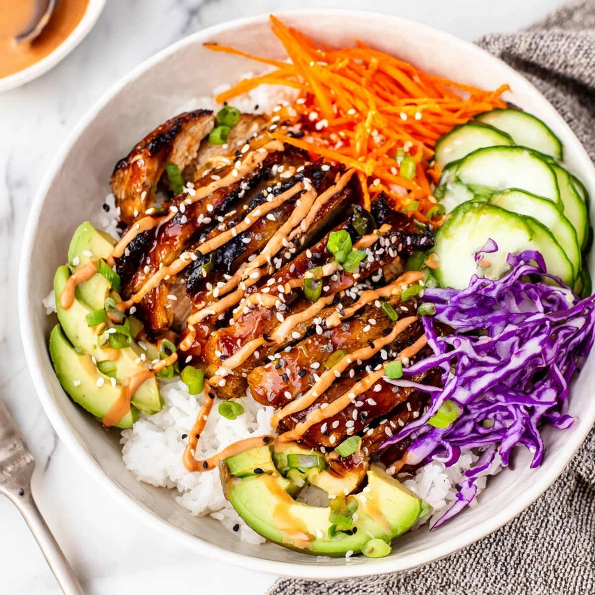 Vibrant meal prep bowl featuring marinated chicken, crisp vegetables, and tangy gochujang mayo atop steamed white rice