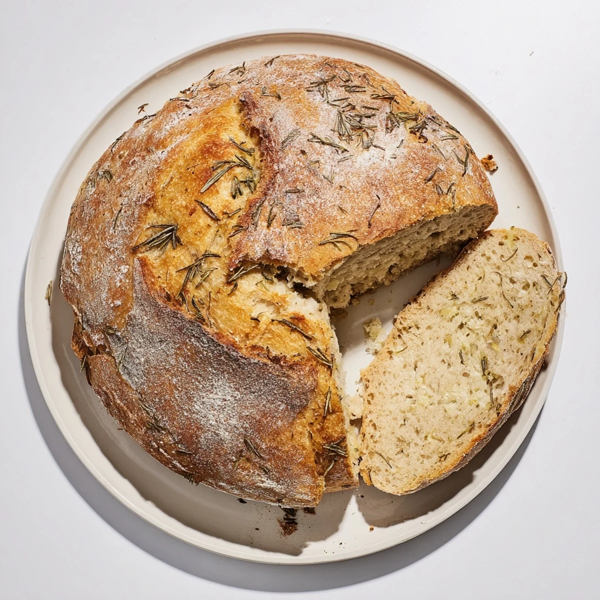 Warm sliced garlic rosemary bread showing soft crumb texture and golden crust on wooden board