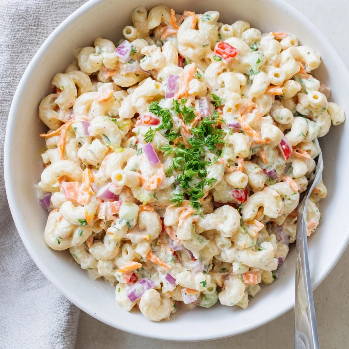Classic American macaroni salad featuring tender pasta and crunchy crisp veggies in smooth tangy sauce
