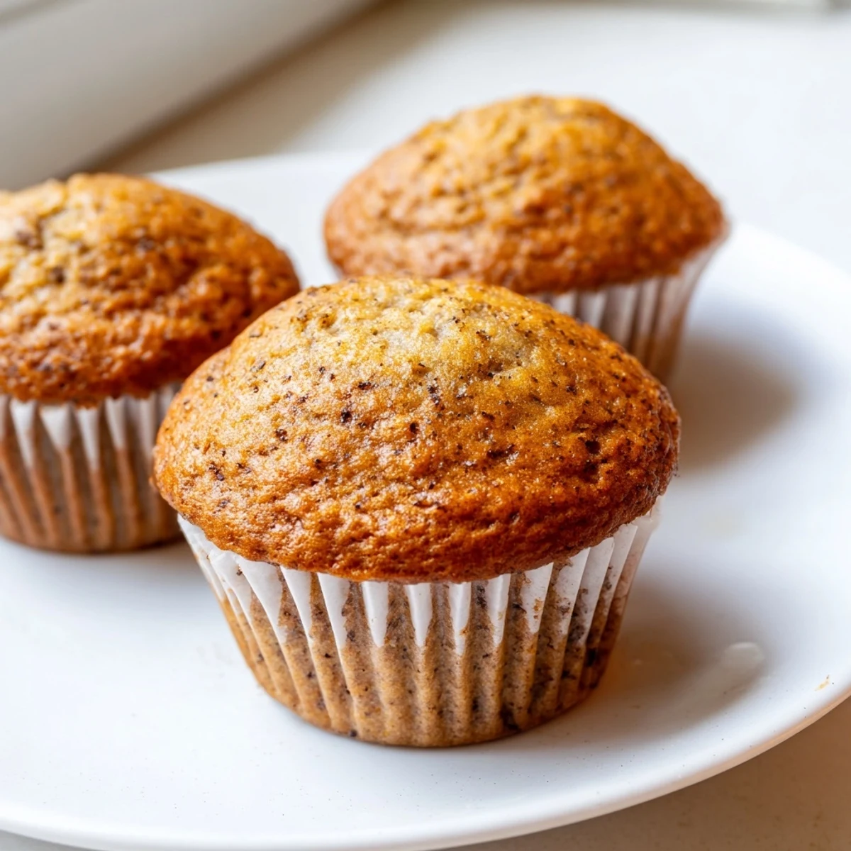 Soft moist banana muffins arranged on a plate for a cozy morning breakfast