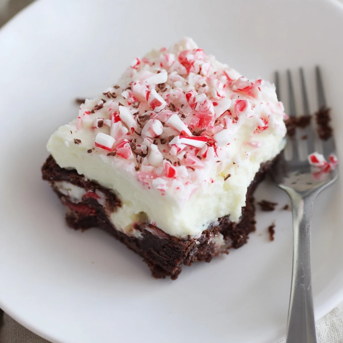 Chilled Peppermint Poke Cake with fluffy whipped topping and crushed candies