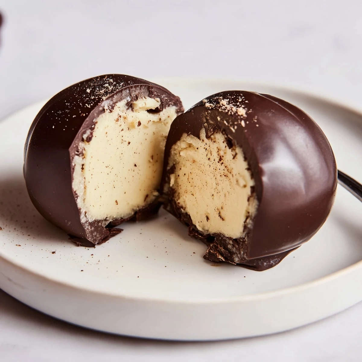 A box of Dark Chocolate Eggnog Truffles tied for gifting, rich spiced aroma