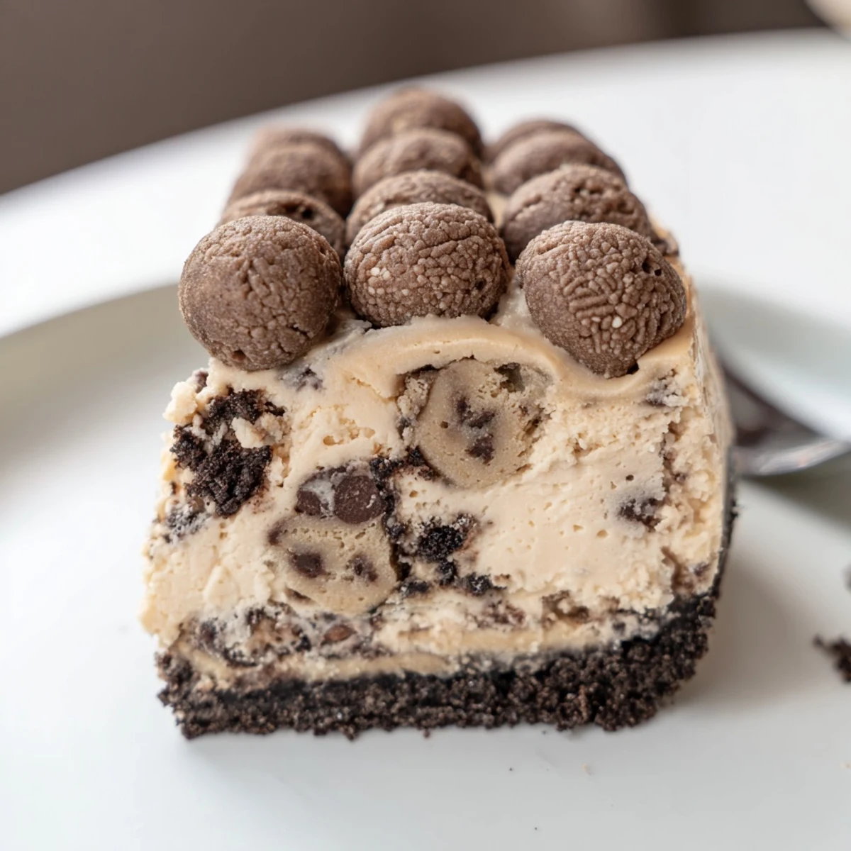 Homestyle Chocolate Chip Cookie Dough Cheesecake with crisp chocolate crust, spoon-ready.
