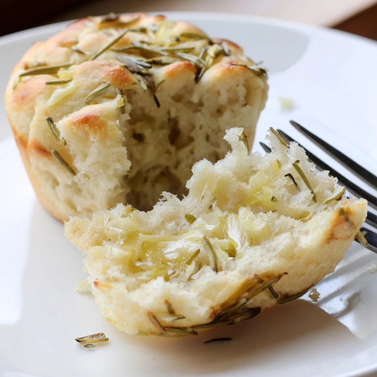 Fresh-baked Garlic Rosemary Focaccia Muffins split open, tender crumb, garlic aroma.