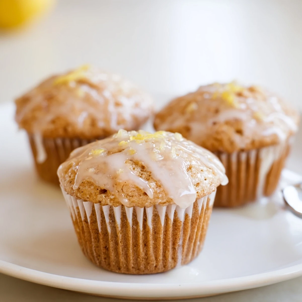 Glazed Lemon Ginger Muffins with shiny citrus glaze, warm steam rising  