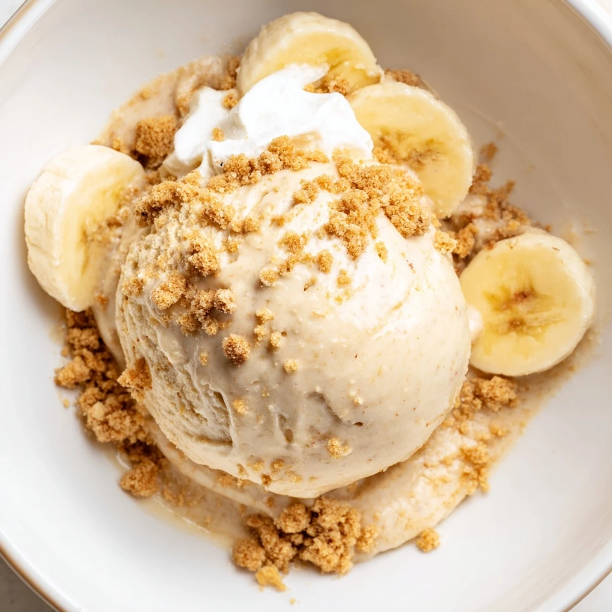 Creamy Ninja Creami Banana Cream Pie Ice Cream topped with whipped cream