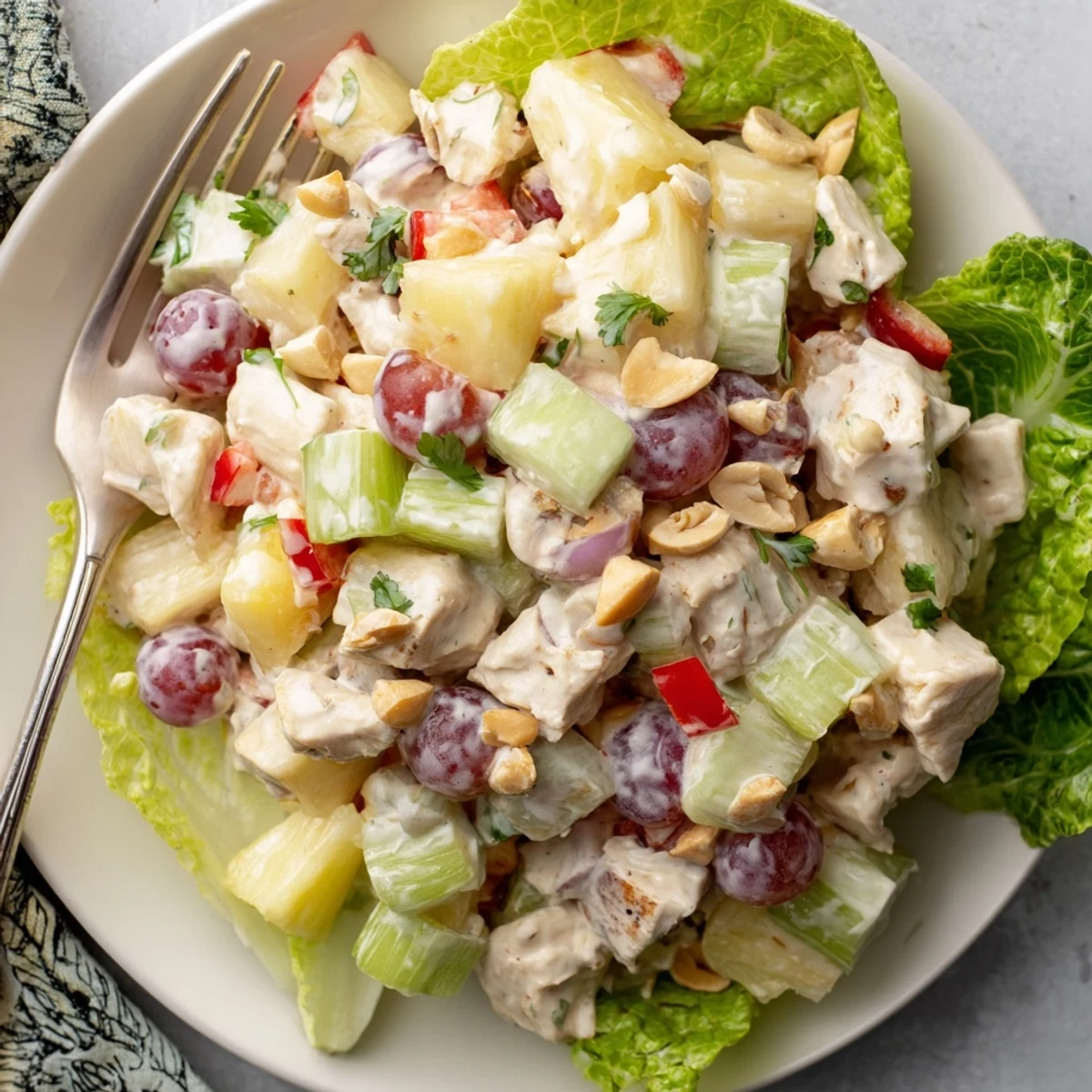 Colorful Hawaiian Chicken Salad Recipe served on butter lettuce, sprinkled macadamias