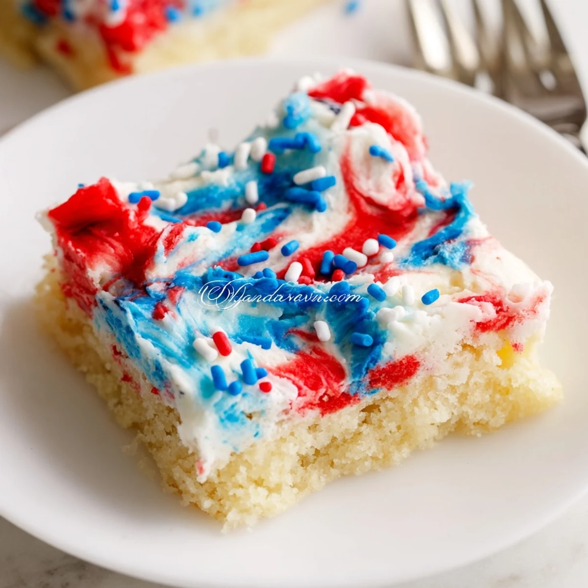 Patriotic Sugar Cookie Bars 4th Of July Dessert Recipe swirled red, white, blue frosting