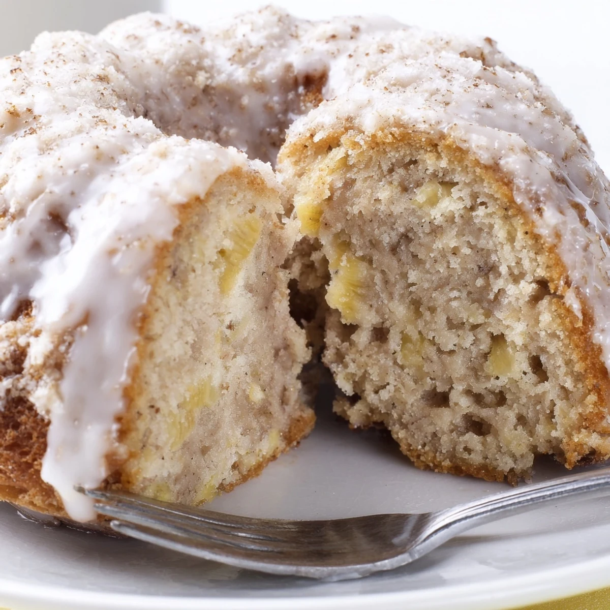Stacked Banana Donuts beside steaming coffee, tender banana flavor and cake-like texture