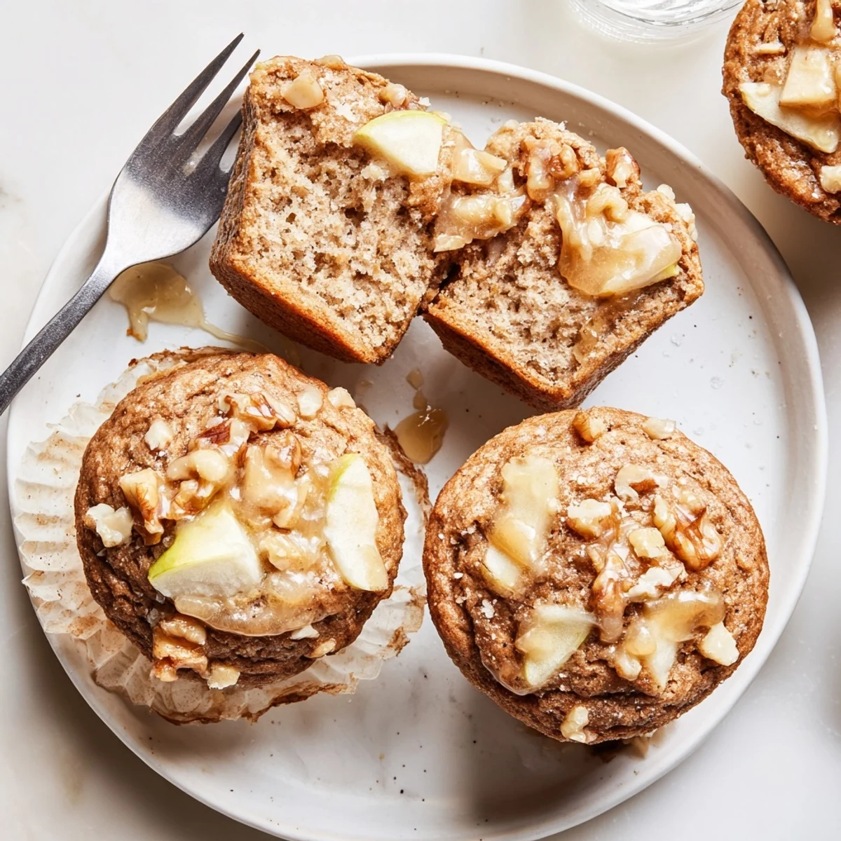 Plate of Healthy Apple Cinnamon Greek Yogurt Muffins with steaming crumbly tops  