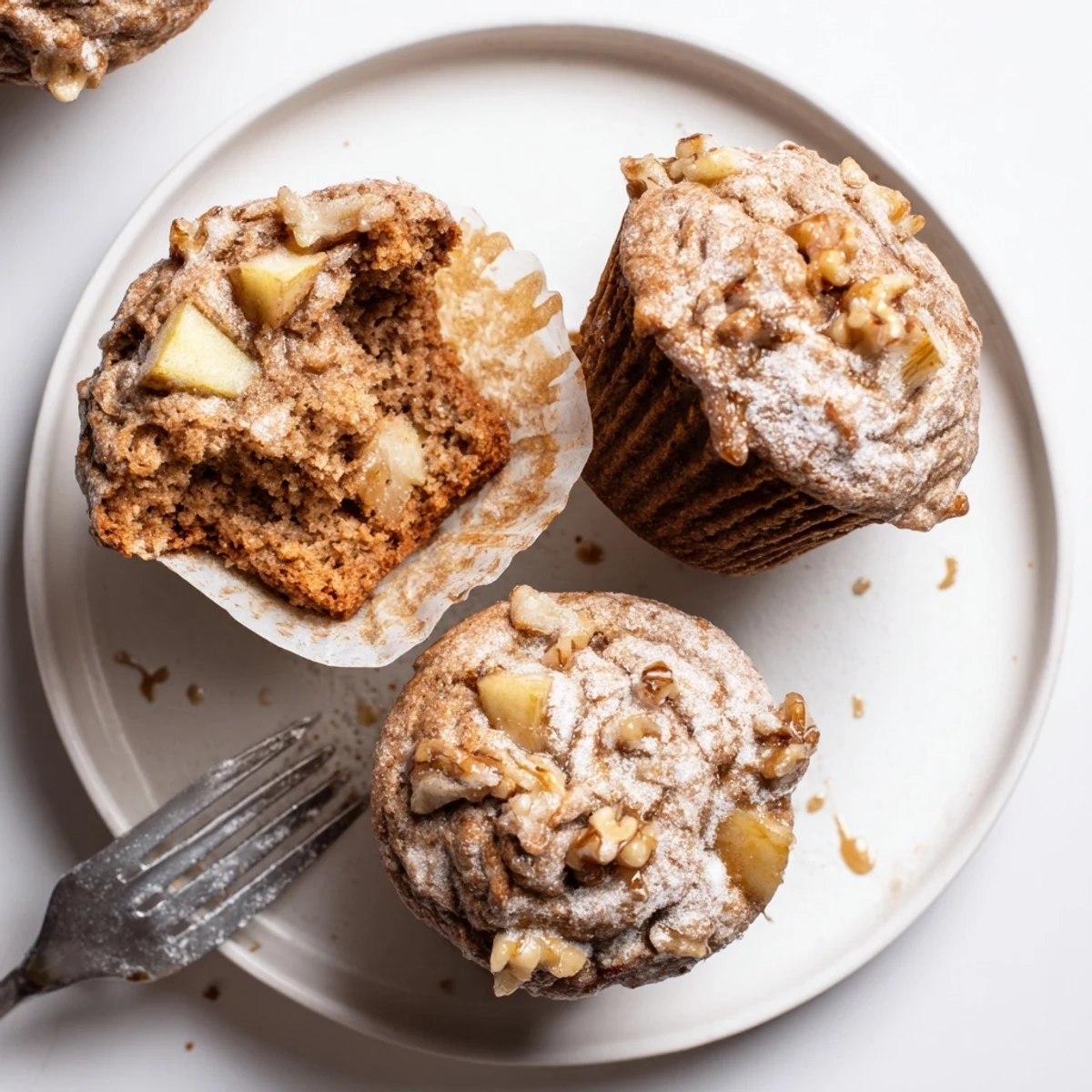 Stack of Healthy Apple Cinnamon Greek Yogurt Muffins on wire rack, cinnamon-scented