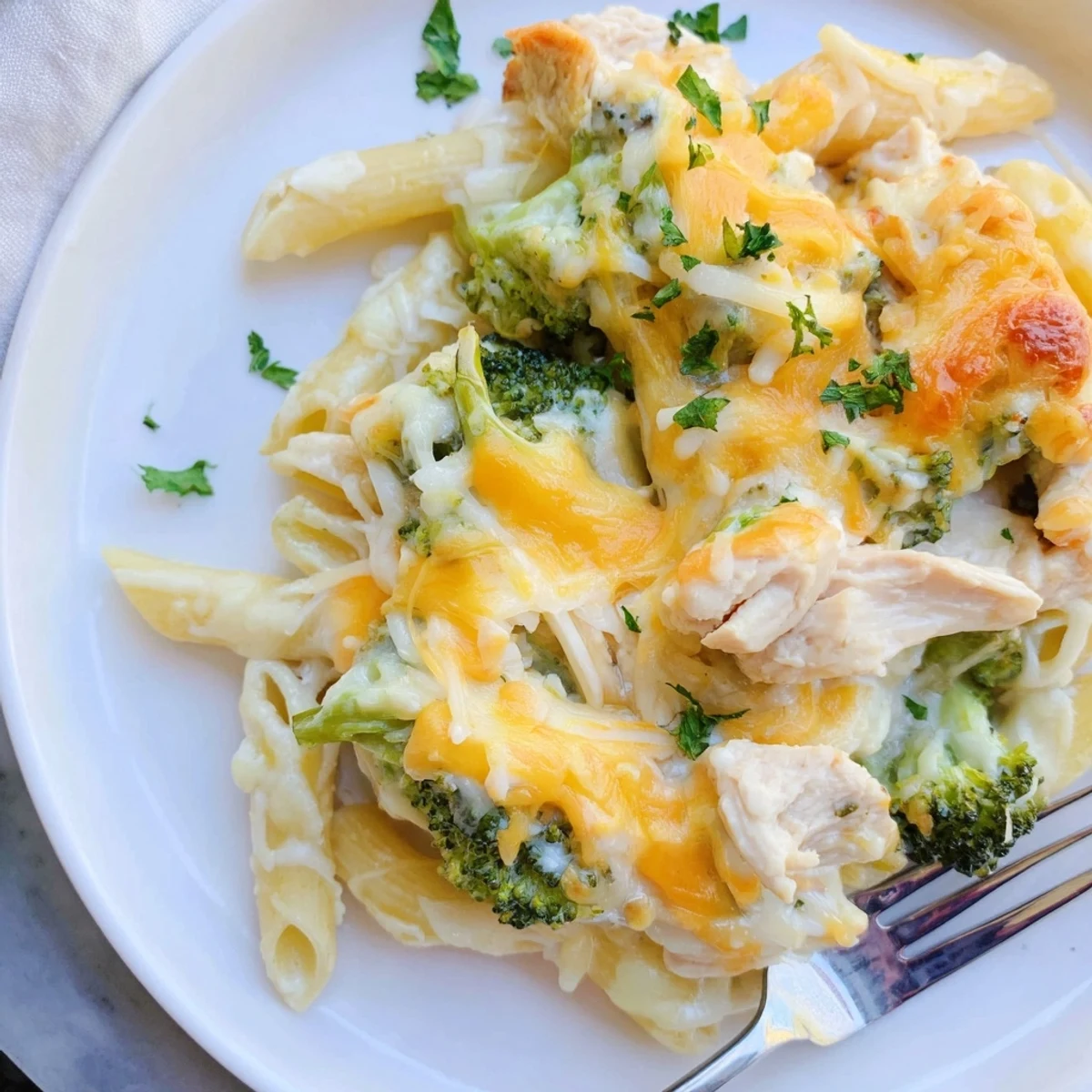Creamy Chicken Broccoli Alfredo Bake Recipe with golden cheese, steaming on table