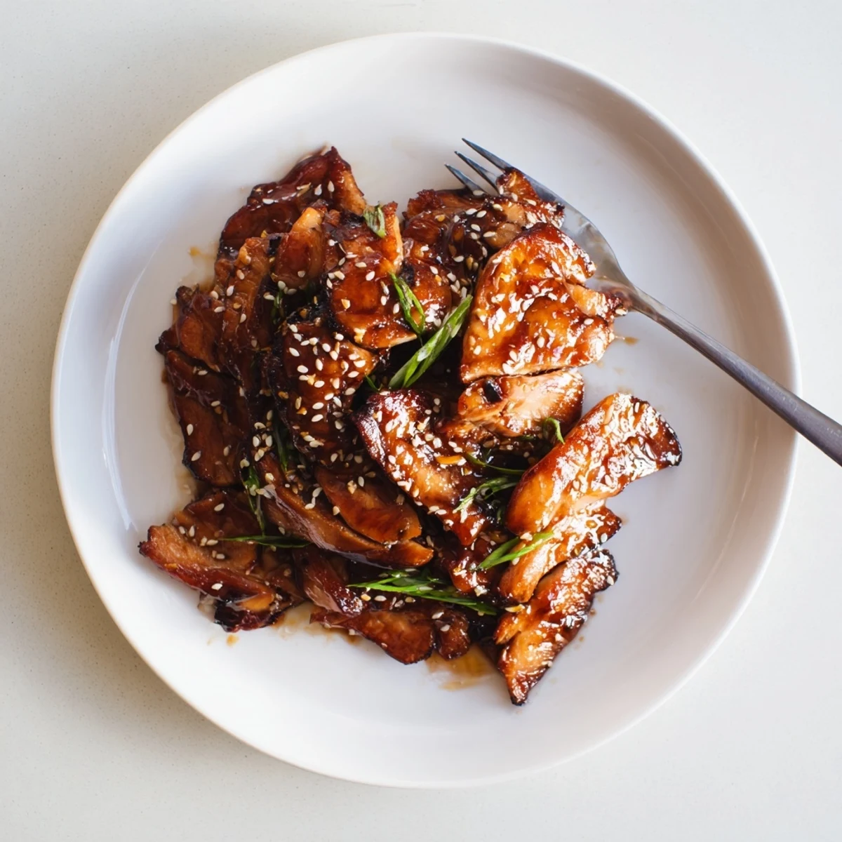 Tender roasted chicken thighs glazed with sticky hoisin honey char siu sauce, caramelized to deep reddish-brown perfection