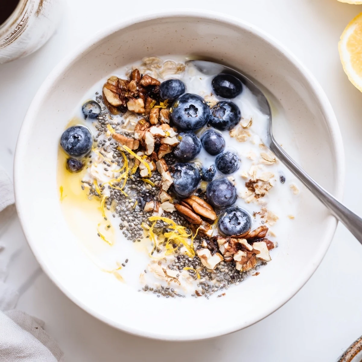 Blueberry Lemon Overnight Oats in mason jars, creamy, chilled, topped with extra blueberries
