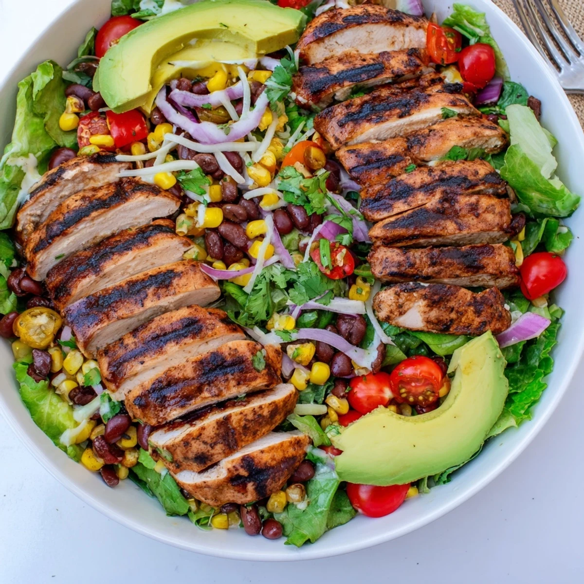 Grilled-spiced Southwestern Chicken Salad served warm on a bed of mixed greens