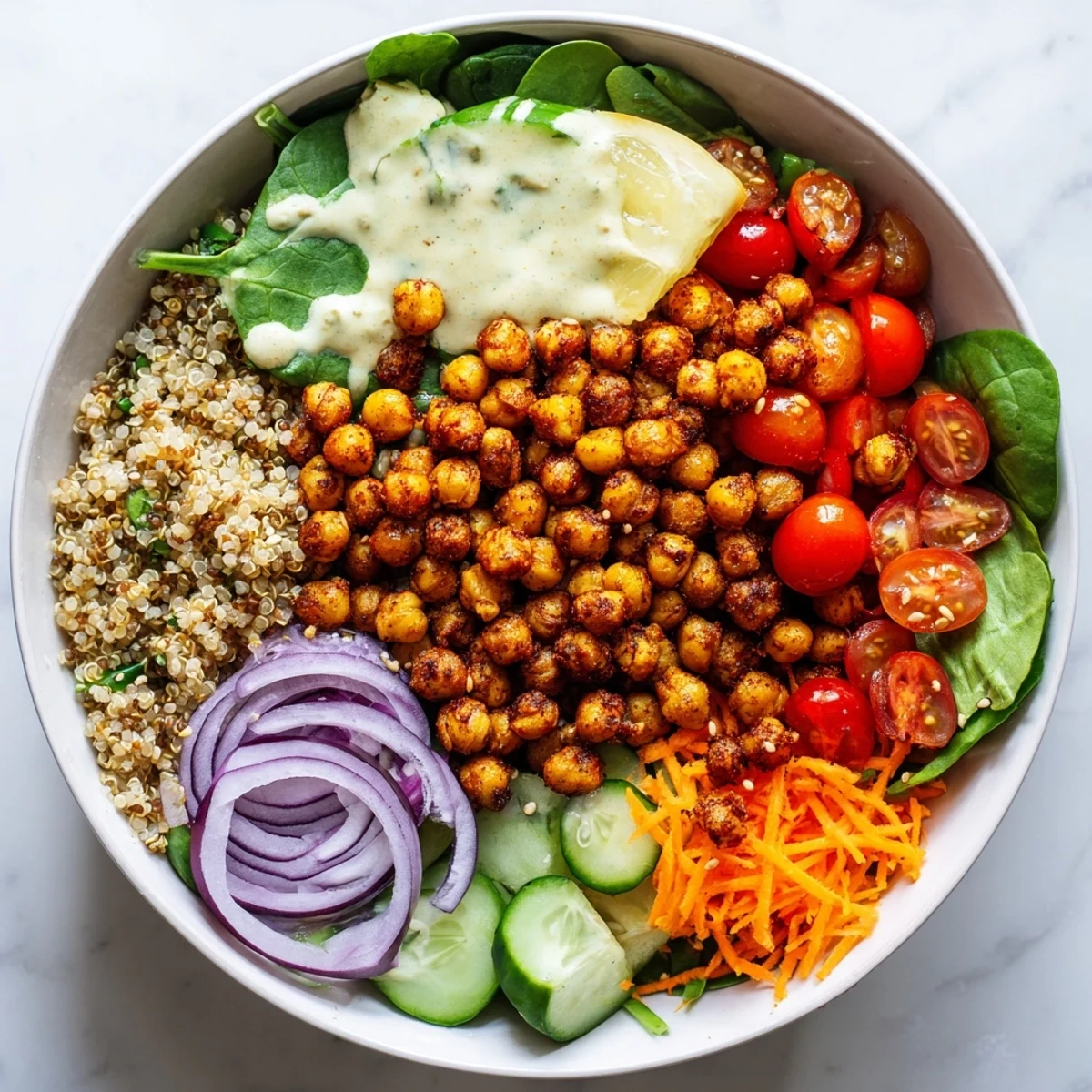 Crispy roasted chickpea and fluffy quinoa chickpea bowl served in a white ceramic dish