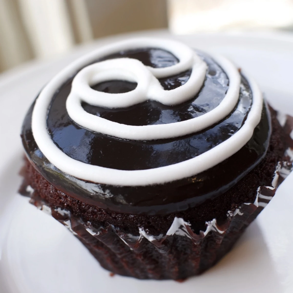 Homemade Hostess Cupcakes with glossy chocolate ganache and a fluffy marshmallow center