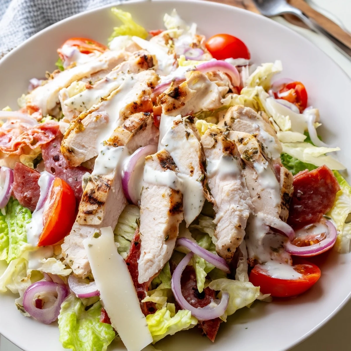 Hearty Italian Grinder Chicken Salad piled with deli meats and zesty dressing