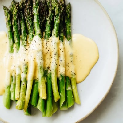 Fresh roasted asparagus with golden edges, served warm as an elegant spring side dish for dinner.